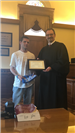 Judge handing young man certificate